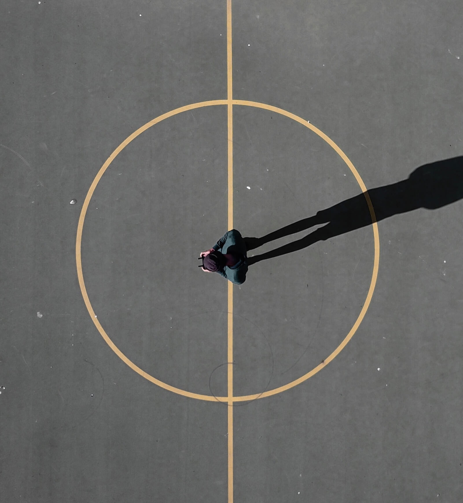 Ariel view of person standing on a concrete foor